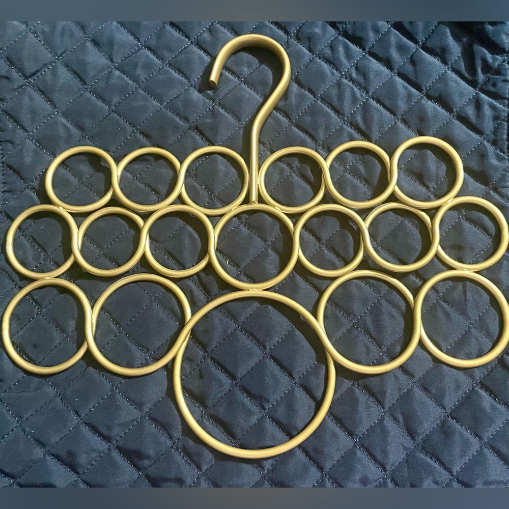 Matte Gold scarf holder, 18 multi-sized holes with hanger style hook to hang up.